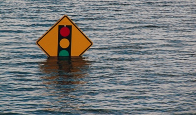 A sign under water is a metaphor for troubled business times.